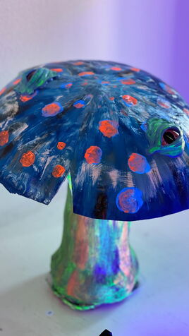 Leuchtende Pilz Skulptur mit flachem, blauem Hut und Augen